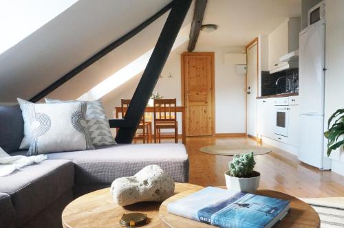a living room with a couch and a table at Kåseberga Hideout in Kåseberga