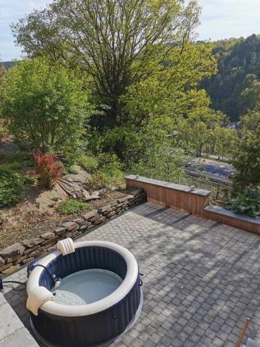 a bath tub sitting on top of a patio at VILLA GABRIEL in Trois-Ponts