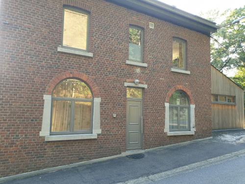 a red brick building with a door and windows at VILLA GABRIEL in Trois-Ponts