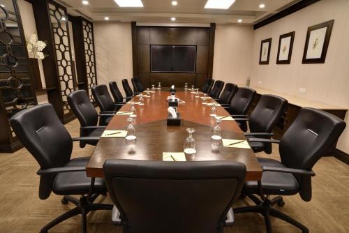 a large conference room with a long table and chairs at Pearl Continental Hotel, Karachi in Karachi
