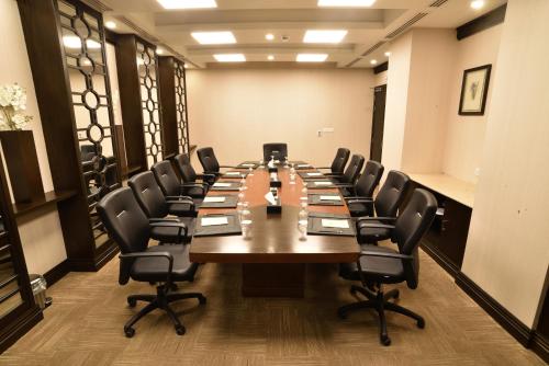 a large conference room with a long table and chairs at Pearl Continental Hotel, Karachi in Karachi
