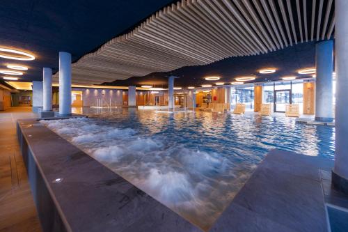 a large indoor swimming pool with water bubbles at Alpen Resort Bivio in Livigno
