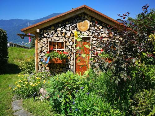 ein kleines Haus mit einer Tür in einem Garten in der Unterkunft Fewo Strauss in Ossiach