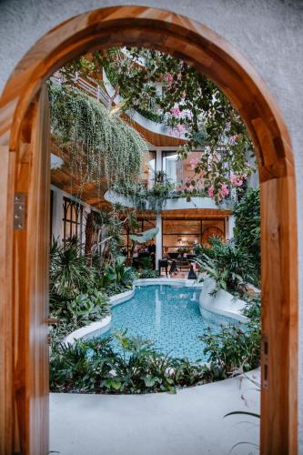 an archway leading to a pool in a house at CityHouse - CityOasis in Ho Chi Minh City