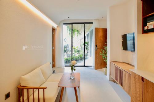 a living room with a couch and a table at CityHouse - CityOasis in Ho Chi Minh City