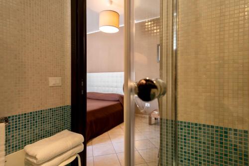a bathroom with a shower with a bed in it at MyBed in Cavallino di Lecce