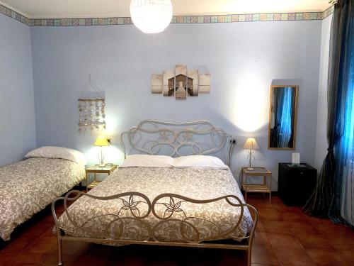 a bedroom with two beds and a blue wall at B&B Residenza Marina in Marina di Carrara