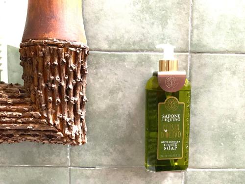 a bottle of soap sitting next to a waffle at B&B Residenza Marina in Marina di Carrara