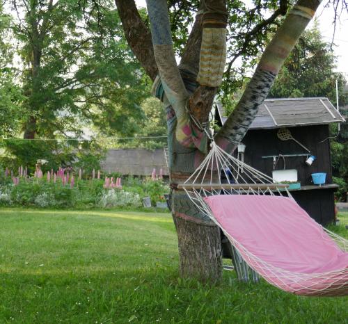 a hammock tied to a tree in a yard at Apartment at Sedliacky Dvor - Brezno in Brezno