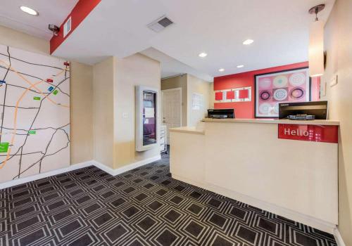a lobby of a hotel with a hello kitty mural at Birch Hills Suites - Blue Ash in Blue Ash