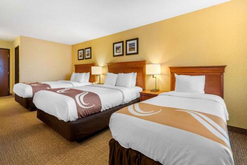 a hotel room with two beds and two lamps at Quality Inn I-25 in Pueblo