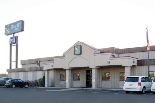 a building with cars parked in a parking lot at Quality Inn Bismarck I-94 in Bismarck