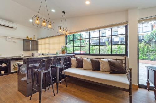 a living room with a couch and a bar at The One Sabai Living Pattaya in Pattaya Central