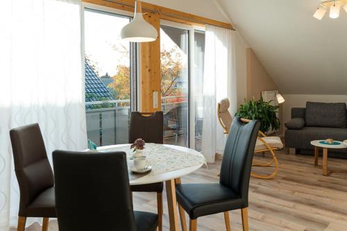 a living room with a table and chairs and a couch at Ferienwohnungen Lohner Höhe in Bad Sassendorf