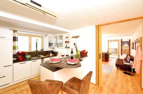 a kitchen and living room with a table and chairs at Urlaub im Stall in Irdning