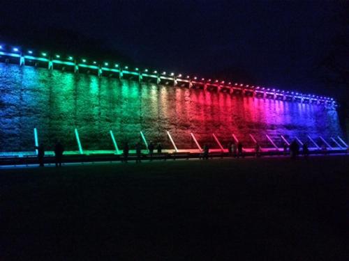 a building lit up with colorful lights at night at Ferienwohnungen Lohner Höhe in Bad Sassendorf