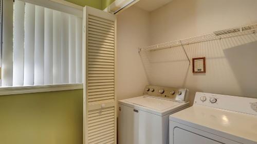 a small laundry room with a washer and dryer at Southwind II at Shipyard in Hilton Head Island
