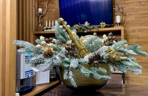 a vase filled with christmas decorations on a table at Lesnoy Country House in Odintsovo