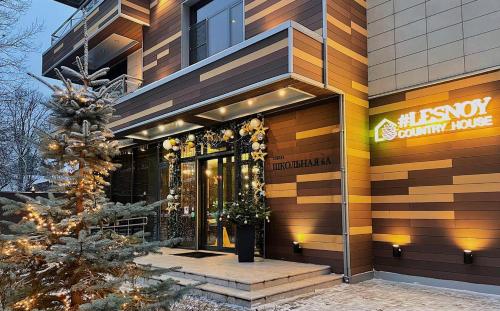 a building with a christmas tree in front of it at Lesnoy Country House in Odintsovo