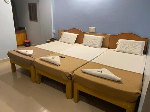 A bed or beds in a room at KVP RESIDENCY