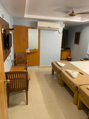 a room with two tables and chairs in a room at KVP RESIDENCY in Tirupati