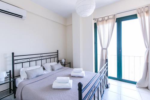 a bedroom with a large bed with two towels on it at Kissakas Villas in Leonidion