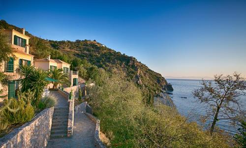 a stairway leading down a hill next to the ocean at Kissakas Villas in Leonidion
