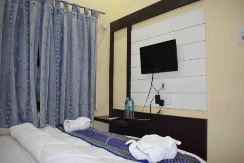 a hotel room with a bed with towels on it at Hotel Mrk in Varanasi