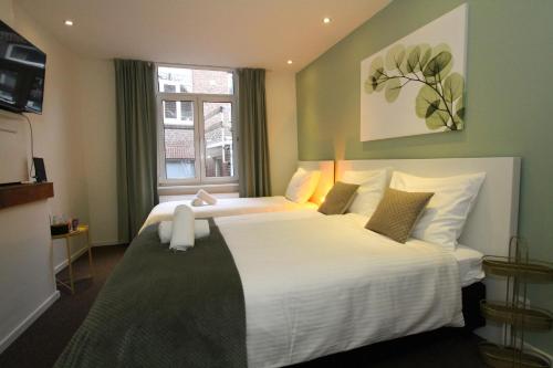 Postel nebo postele na pokoji v ubytování De Stadswal