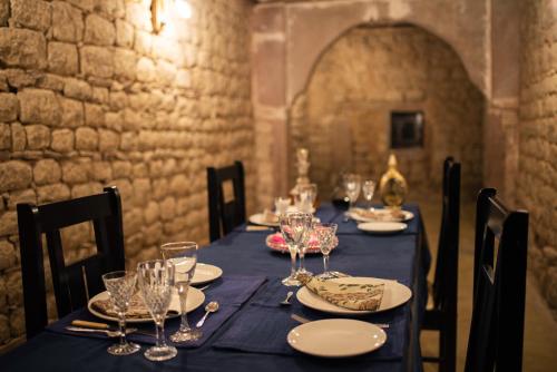 a long table with glasses and plates on it at Kot Dunara - A 16th Century Castle near Jodhpur in Jodhpur