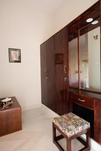 a room with a wooden cabinet and a stool at Kot Dunara - A 16th Century Castle near Jodhpur in Jodhpur
