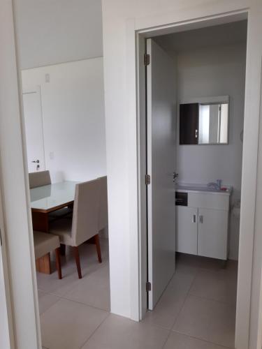 a kitchen and dining room with a table and a dining room at Apartamento em ótima localização in Torres