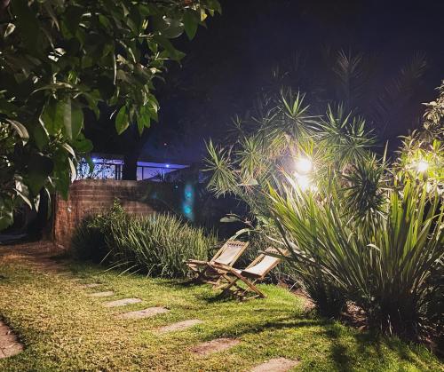a couple of benches sitting in the grass at night at Posada Colibri - Hotel & Spa in San Juan Teotihuacán