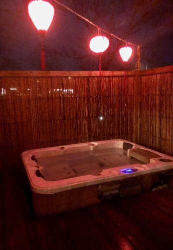 a large bath tub in a room with two lights at Pensionat Kanalvillan in Väddö