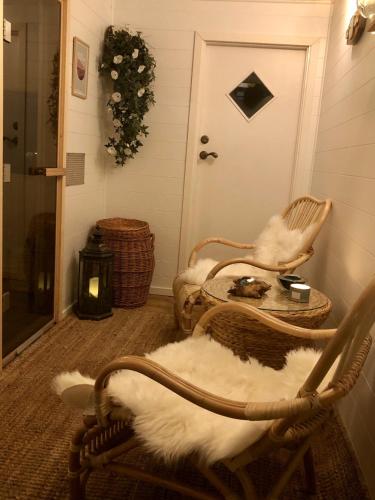 a room with two chairs and a table and a door at Pensionat Kanalvillan in Väddö