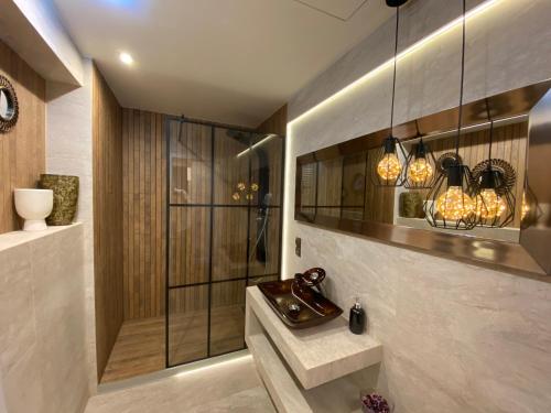 a bathroom with a walk in shower and a sink at P&J Apartments Lubicz in Kraków