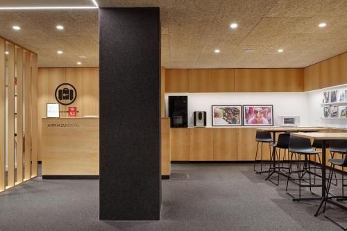 a lobby with a table and some chairs and a counter at Hostal Arriazu in Pamplona