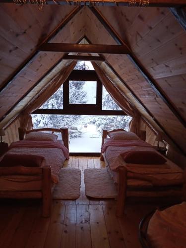 a room with four beds in a wooden attic at Dorina hiža in Karlovac