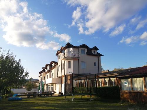 a large white building with a balcony on top of it at Hotel Zenit Satovcha in Satovcha