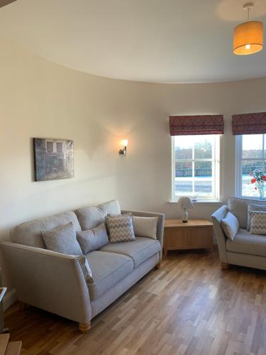 a living room with a couch and two chairs at Rohallian in Stanley