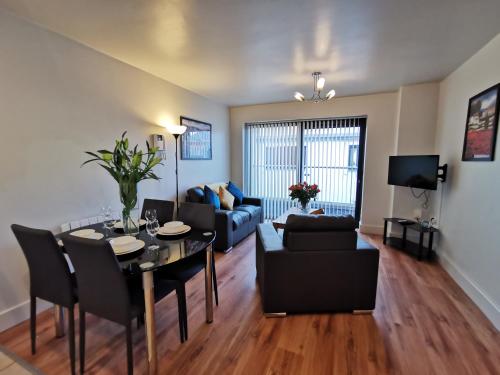 a living room with a dining room table and a couch at Milligan Court Townhouses in Sligo