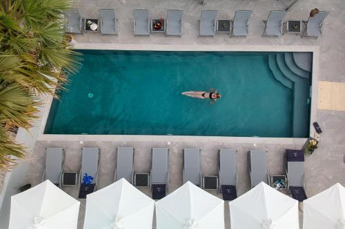 an overhead view of a man swimming in a pool at Angels Pillow Luxury Boutique Residence - Adults Only in Naousa