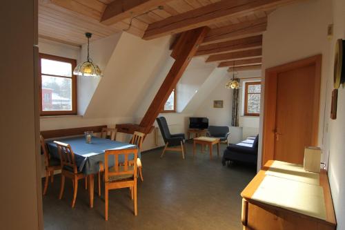 a room with a table and chairs and a living room at Haflingerhof Galster in Markt Taschendorf