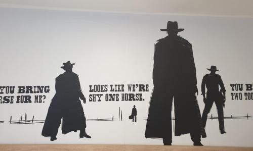 a painting of three men with signs on a wall at Penzion Via Ferrata in Děčín