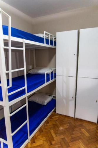a room with two bunk beds and a closet at Solar Hostel Beach Copacabana in Rio de Janeiro