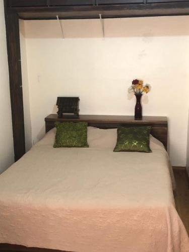 a bedroom with a bed and a lamp at Airport Rio Segundo Studio in Alajuela