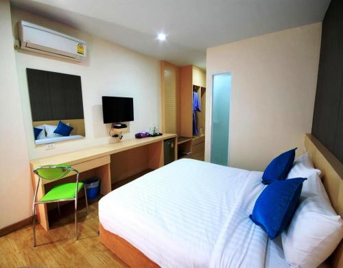 Schlafzimmer mit einem Bett und einem Schreibtisch mit einem Computer in der Unterkunft S3 Residence Park in Bangkok