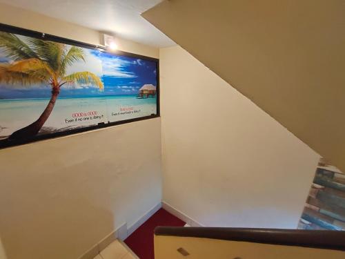 a room with a picture of a palm tree on the wall at MALABAR Residency in Perintalmanna