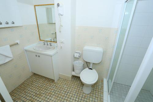 a bathroom with a toilet and a sink and a shower at St Tropez Resort in Gold Coast