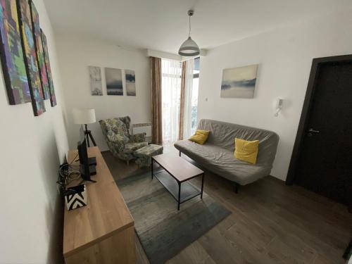 a living room with a couch and a table at Lux apartman Zlatibor in Zlatibor